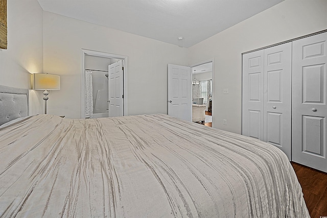 unfurnished bedroom featuring connected bathroom and dark wood-type flooring