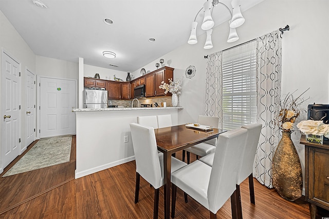 dining area featuring dark wood-type flooring and sink