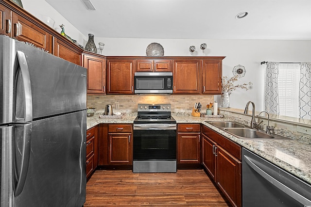 kitchen with sink, dark hardwood / wood-style flooring, backsplash, and appliances with stainless steel finishes