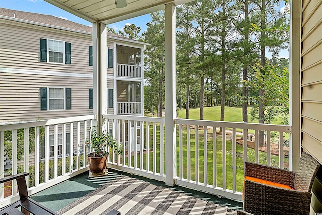 wooden terrace with a lawn