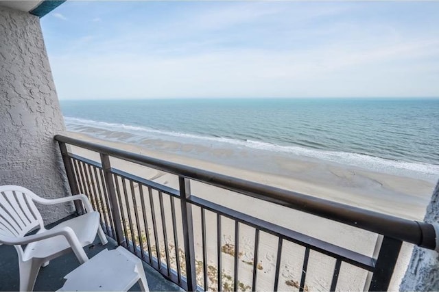 balcony with a beach view and a water view