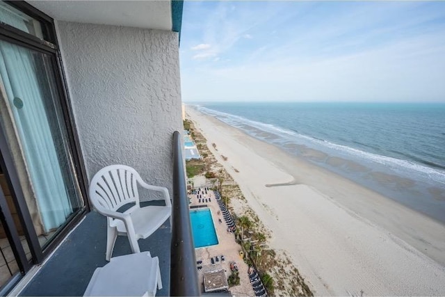 balcony with a view of the beach and a water view