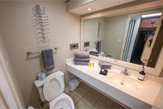 bathroom with tile patterned floors, sink, and toilet