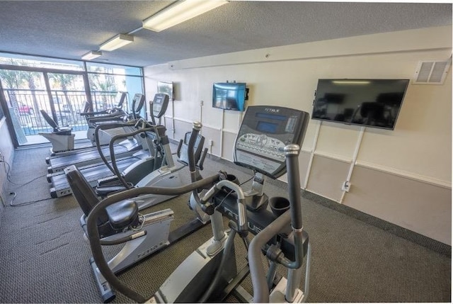 exercise room featuring a textured ceiling