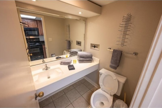 bathroom featuring toilet, tile patterned floors, and sink