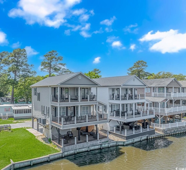 back of house with a water view and a balcony