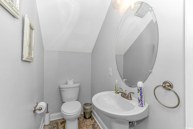 bathroom featuring tile floors, sink, lofted ceiling, and toilet