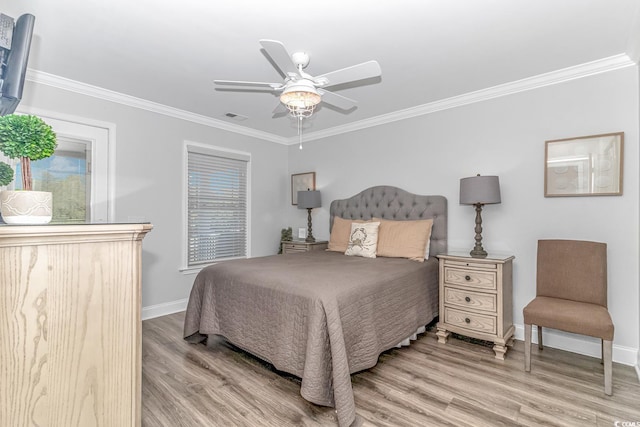 bedroom featuring crown molding, ceiling fan, and light hardwood / wood-style flooring