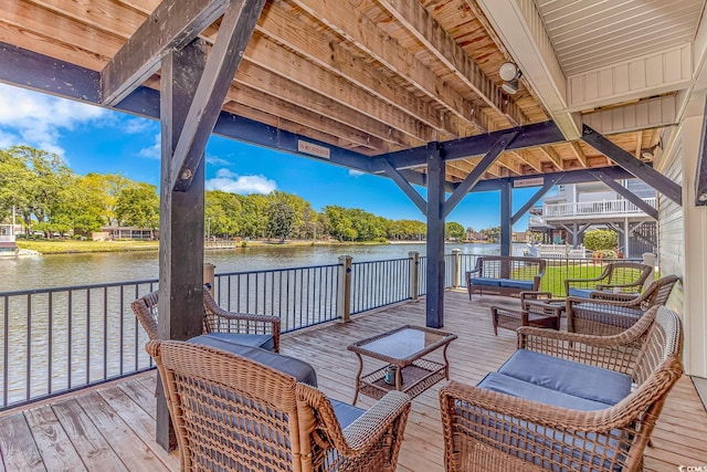 wooden deck featuring an outdoor living space and a water view