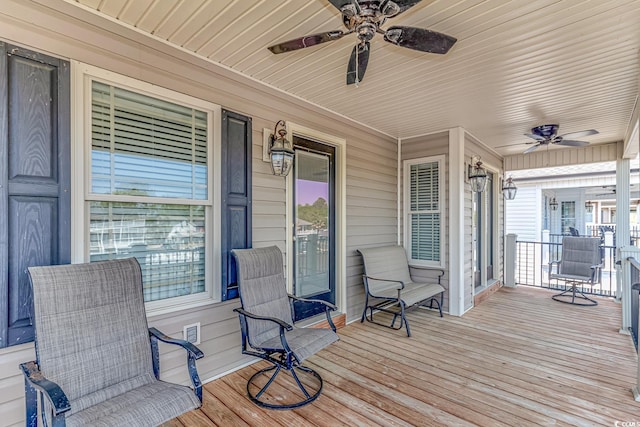 wooden deck featuring ceiling fan