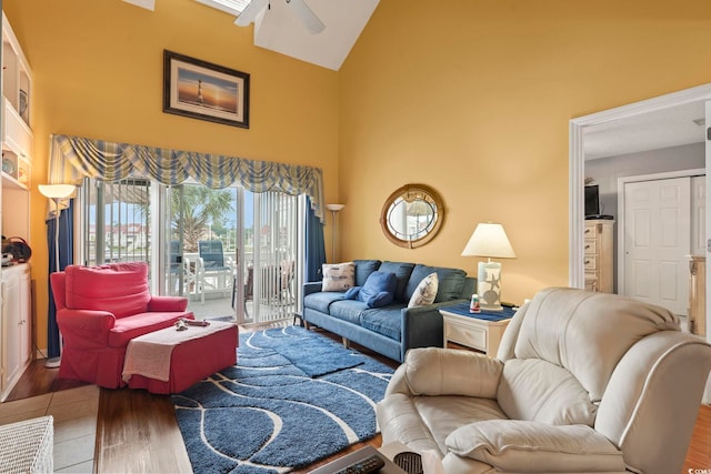 living area featuring high vaulted ceiling, ceiling fan, and wood finished floors