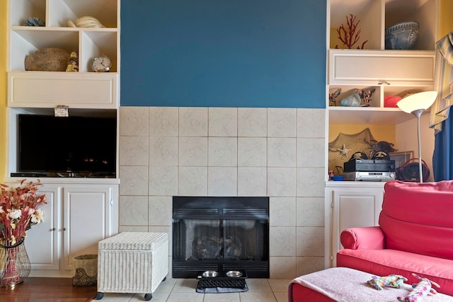 tiled living room featuring tile walls and a fireplace