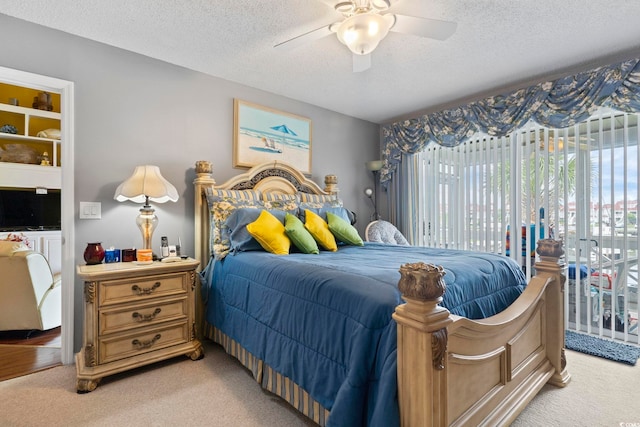 bedroom with access to outside, a textured ceiling, ceiling fan, and light carpet
