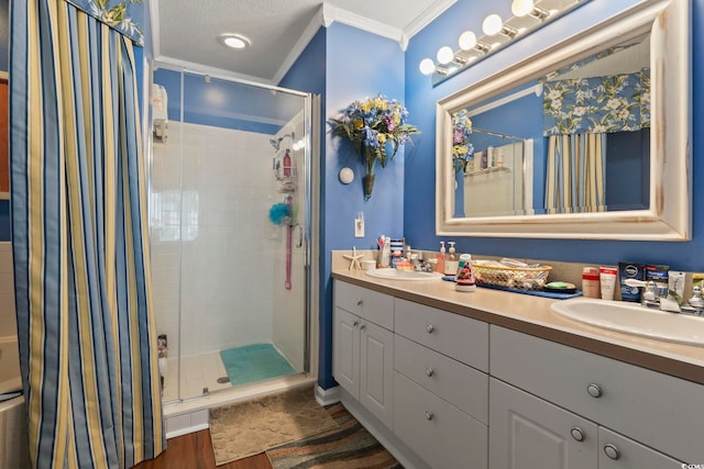 bathroom featuring a textured ceiling, hardwood / wood-style flooring, ornamental molding, vanity, and a shower with curtain