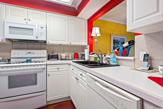 kitchen with sink, white cabinetry, decorative backsplash, and white appliances