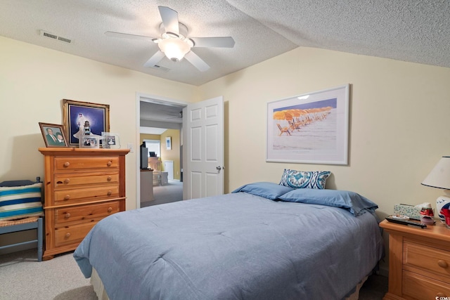 bedroom with ceiling fan, light carpet, a textured ceiling, lofted ceiling, and visible vents