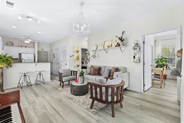 242 Sun Colony Blvd Unit 101, Longs, SC 29568 - living area with light wood finished floors, a chandelier, and a ceiling fan