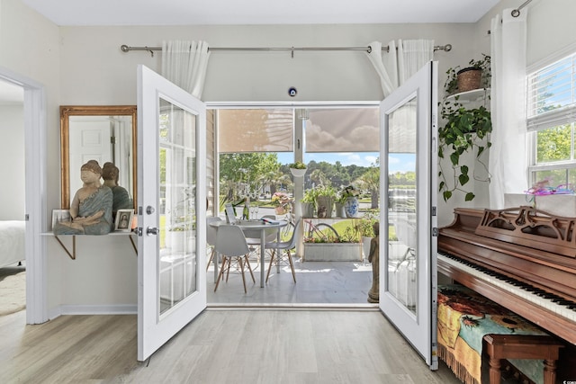 doorway with french doors and light hardwood / wood-style floors