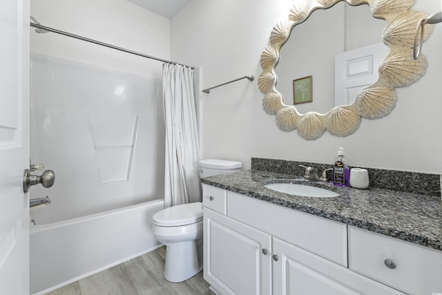 full bathroom featuring hardwood / wood-style floors, vanity, toilet, and shower / bath combination with curtain