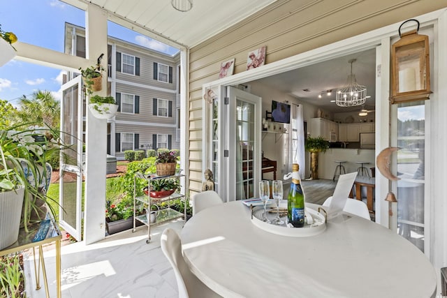 sunroom / solarium with an inviting chandelier and a healthy amount of sunlight