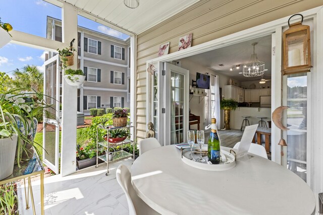 242 Sun Colony Blvd Unit 101, Longs, SC 29568 - sunroom featuring a chandelier and healthy amount of natural light