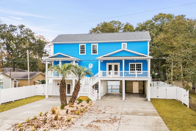 view of front of home with a porch and a carport