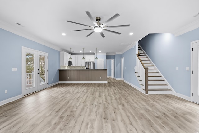 unfurnished living room featuring crown molding, ceiling fan, and light hardwood / wood-style floors