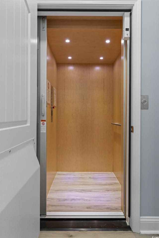 interior details featuring elevator and recessed lighting