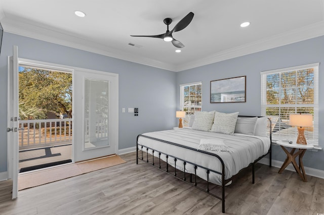 bedroom with multiple windows, crown molding, and access to exterior
