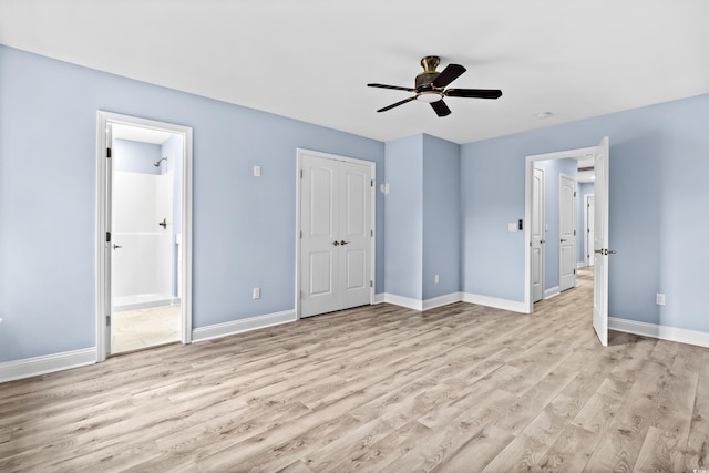 unfurnished bedroom featuring ceiling fan, ensuite bathroom, and light wood-type flooring