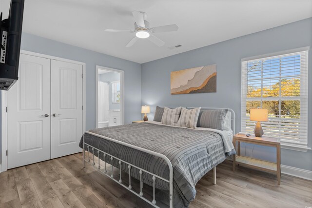 unfurnished bedroom featuring ensuite bathroom, a closet, ceiling fan, and light hardwood / wood-style floors