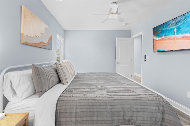 bedroom featuring baseboards and ceiling fan
