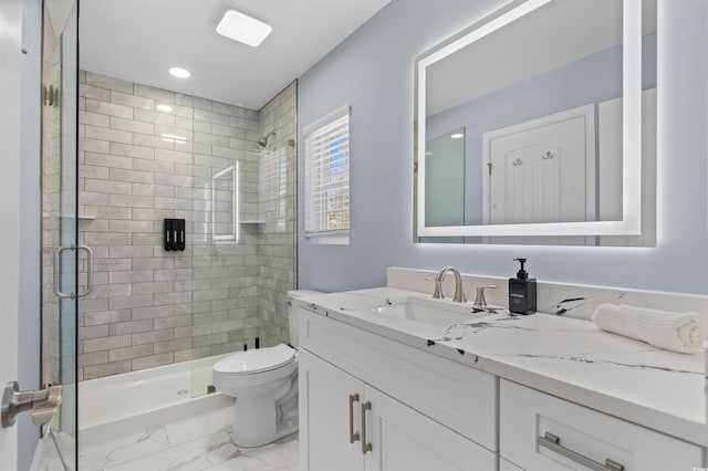 bathroom with marble finish floor, vanity, toilet, and a stall shower