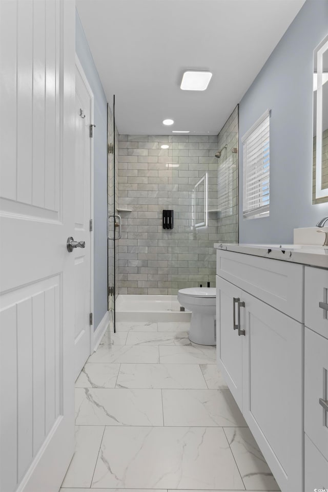 full bathroom with marble finish floor, toilet, vanity, and a shower stall
