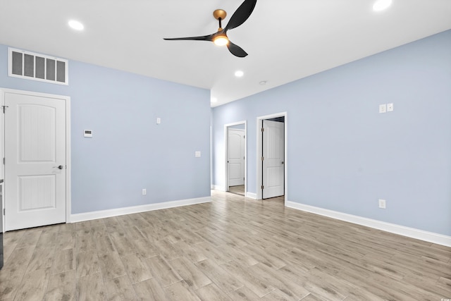 spare room with ceiling fan and light wood-type flooring