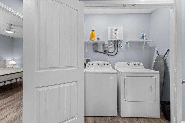 laundry area featuring wood finished floors, laundry area, separate washer and dryer, and a ceiling fan