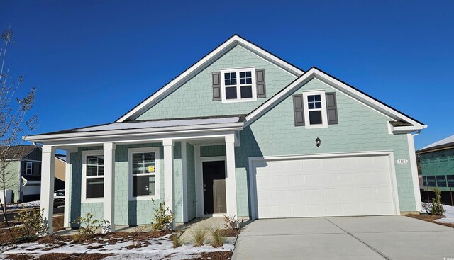 view of front of house with a front yard and a garage