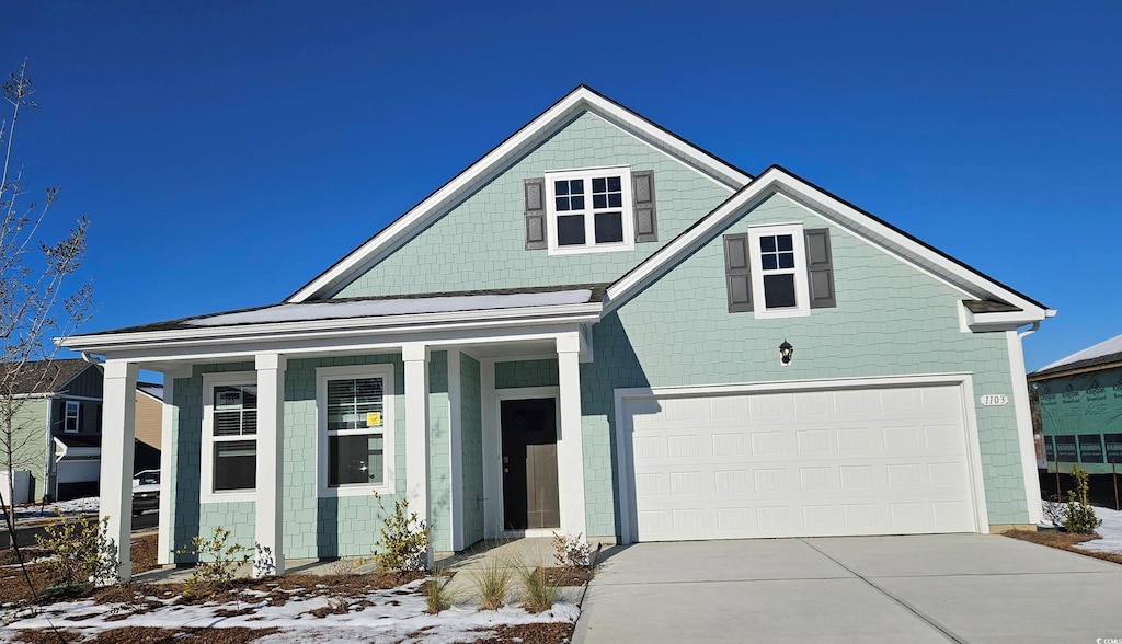 view of front of house with a front yard and a garage