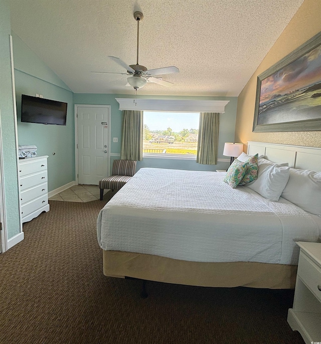 carpeted bedroom featuring a textured ceiling, lofted ceiling, and ceiling fan