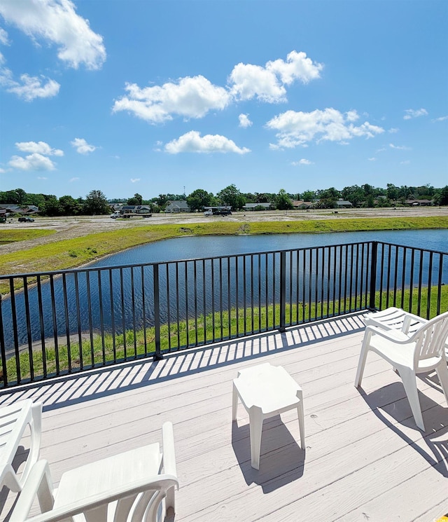 wooden terrace featuring a water view