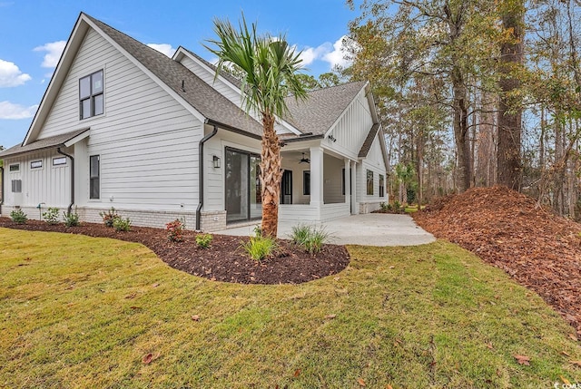 view of home's exterior with a lawn, a patio area, and ceiling fan