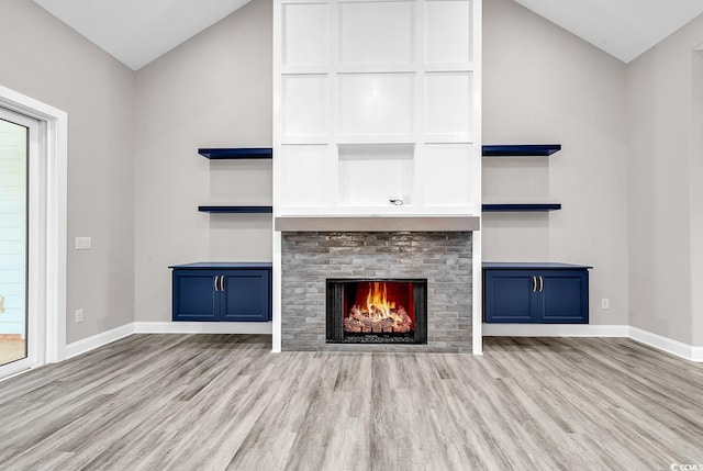 unfurnished living room featuring lofted ceiling and light wood-type flooring