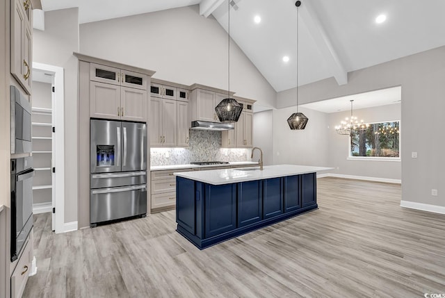 kitchen featuring sink, hanging light fixtures, light hardwood / wood-style flooring, beamed ceiling, and stainless steel appliances