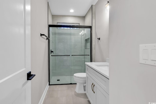 bathroom with vanity, an enclosed shower, and toilet