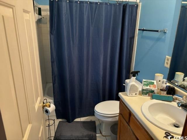 full bathroom featuring vanity, toilet, tile floors, and shower / bath combo