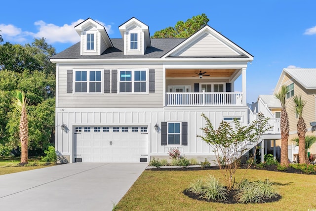 view of front facade featuring ceiling fan, a balcony, a front yard, and a garage