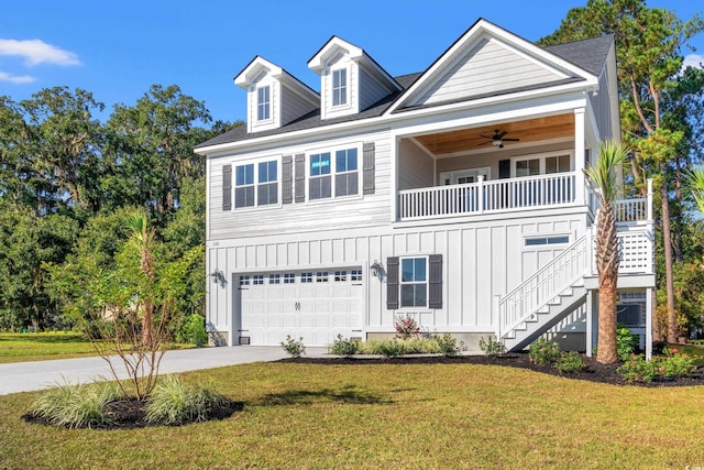 view of front of home with a garage, a front lawn, and ceiling fan