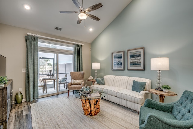 living room with high vaulted ceiling, ceiling fan, and wood-type flooring