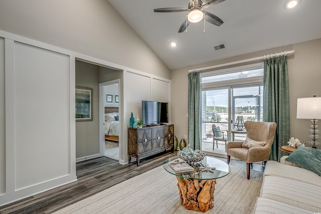 living room with high vaulted ceiling, ceiling fan, and dark wood-type flooring