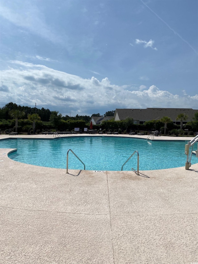 view of swimming pool with a patio